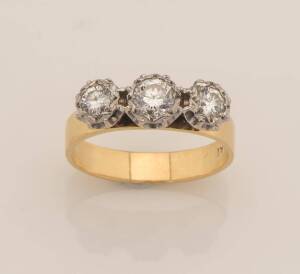 A three stone diamond ring, estimated diamond weight 0.70 carat. 18ct gold. Weight 4.4 grams. Size P.