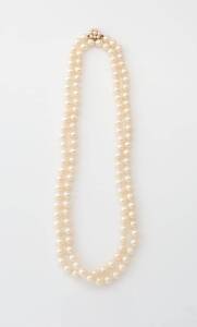 A matinee length Akoya pearl necklace, 6.6-7mm, individually knotted with a 14ct yellow gold pearl cluster clasp. Length 46cm.