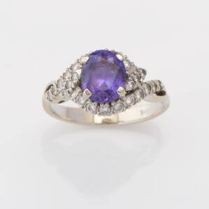 A purple sapphire and diamond ring, the sapphire measuring 7.94 x 6.51 x 5.46 mm, estimated weight 2.26 carats. 18ct white gold. Weight 4.26 grams. Size M. 