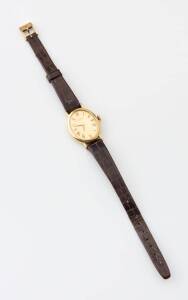 A Lady's gold IWC wristwatch, oval case, 22mm. Manual. Calibre 412. Gold dial with painted black Roman numerals. Case, dial, movement and signed. 18ct yellow gold. Leather strap.