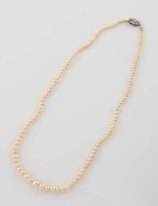 A graduated cultured pearl necklace, 2.7 - 6mm, hung with a gold and diamond clasp. Length 40cm.