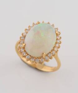 A solid white opal and diamond cluster ring. 18ct yellow gold. Weight 6.43 grams. Size O &frac12;.