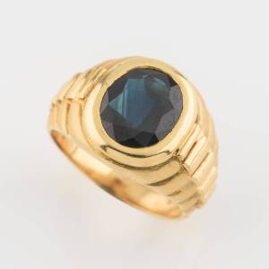 A sapphire signet ring, the Rolex style mount set with an oval blue sapphire measuring 9.1 x 4.47mm, estimated weight 3.73 carats. 14ct yellow gold. Weight 12.27 grams. Size S.