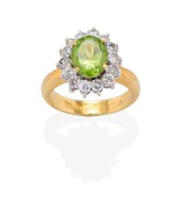 A peridot and diamond cluster ring. 18ct yellow gold. Weight 7.95 grams. Size M &frac12;.