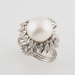A diamond and pearl dress ring, of cluster design with a central pearl. 14ct white gold. Size N. Weight 9.1 grams.&nbsp;