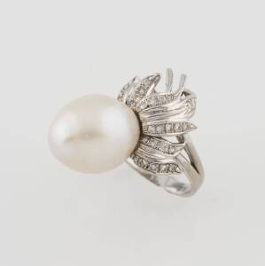 A diamond and pearl dress ring. 14ct White gold. Size P. Weight 11.1 grams.