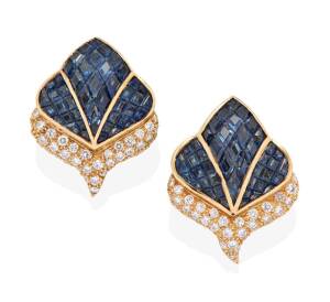 A pair of sapphire and diamond ear clips, of leaf design, calibre sapphires 'invisibly' set above pave diamond section. Post and clip attachments. 18ct yellow gold. Weight 15.12 grams. Length 2.2cm.&nbsp;
