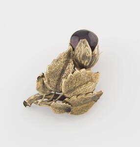 An antique carbuncle brooch, of foliate and floral design. Not marked, but assessed as 18ct yellow gold. Boxed. Weight 10.95 grams.&nbsp;