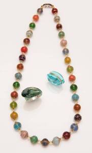 A collection of Baccarat jewellery comprising two rings and a silver necklace. To be sold with a multi-coloured beaded Murano glass necklace.