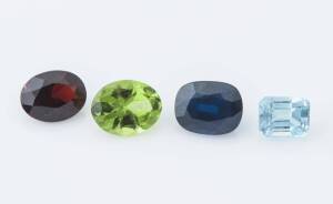 A collection of facetted loose stones including eight bags of sapphires, one bag of garnets, one bag of peridots and a bag containing two aquamarines.
