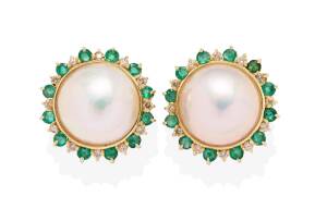 A pair of mabe pearl, emerald and diamond earclips. &nbsp;Post and clip attachments. 14ct yellow gold. Weight 10 grams. Diameter 2cm.