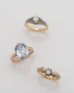 A solitaire diamond ring, estimated weight 0.35 carats. 18ct yellow gold. Weight 3.37 grams. Size M. To be sold with two 9ct blue and clear stone set rings. Weight 5.21 grams. Size L & O.