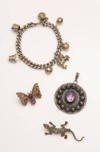 A quantity of silver jewellery including a charm bracelet, a butterfly brooch, a marcasite lizard brooch and an amethyst pendant.