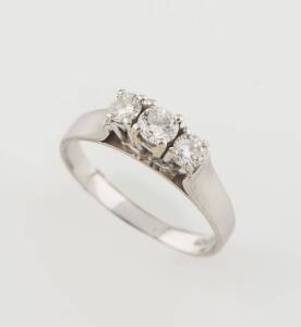 Two three stone diamond rings, one vertically set, the other three across. 18ct white gold. Weight 7.94 grams. Size M.
