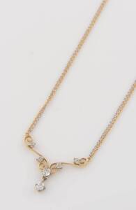 A diamond pendant necklace, the front section of scroll design set with six old brilliant cut diamonds, on a two tone double oval link chain. 18ct yellow and white gold. Weight 6.63 grams.&nbsp;Length 46cm.