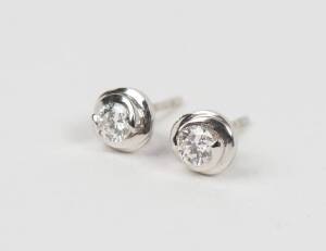 A pair of diamond stud earrings, bezel set, estimated total weight 0.40 carats. 18ct white gold. Weight 1.05 grams.