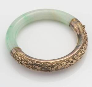 A vintage Chinese repousse silver and jade bangle, floral motif. Silver gilt. Inside diameter 5.8cm.&nbsp;