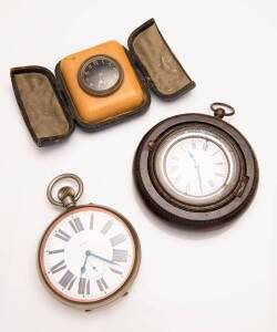 An assortment of time pieces including a Bakelite desk clock, an 8 day over-sized pocket watch and a decorative hanging clock.