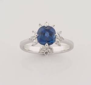 A sapphire and diamond ring, known weight of central cushion shaped blue sapphire 1.64 carats, and diamonds 0.39 carat. 18ct white gold. Weight 3.56 grams. Size K.