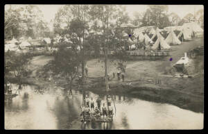 MILITARY - WORLD WAR ONE: 1916 real photo of Mitcham Military Camp (SA) featuring dozens of tents, chopping wood, underground oven & a group of bare-chested soldiers on a makeshift raft, a couple of minor inkspots, used under cover. One of the most appeal