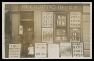 MILITARY Real Photo Card of a Burly Sergeant in the Doorway of the 'RECRUITING OFFICE' festooned with Regimental posters, unused. Ex Keith Harrison. [Probably from late in the war because the recruit looks rather callow!]