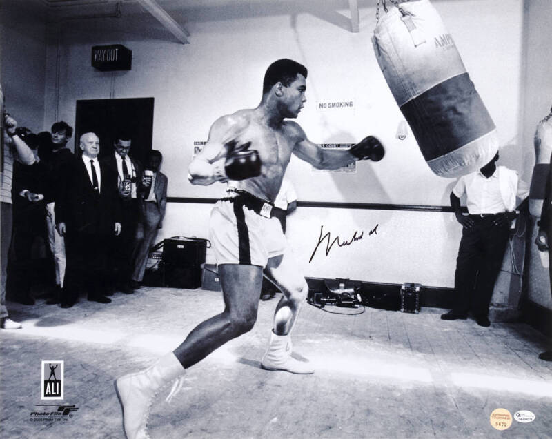 MUHAMMAD ALI signed photograph of Muhammad Ali with punching bag