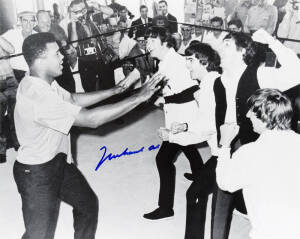 MUHAMMAD ALI & THE BEATLES, photograph of Ali clowning around with The Beatles, signed "Muhammad Ali", size 51x40cm. With CoA No.0510.