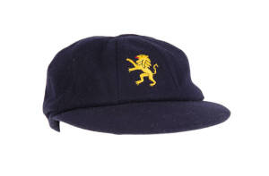 NETHERLANDS CRICKET CAP, navy blue with Dutch Lion logo embroidered on front, worn by Roland Lefebvre in 1983. G/VG condition. {The most successful cricketer that the Netherlands has produced, and one of the very few players from outside the Test-playing 