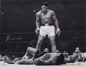 MUHAMMAD ALI, signed b/w photograph of Ali standing over Sonny Liston, size 51x41cm. With 'Online Authentics' No.OA-8090313.