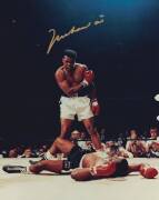 MUHAMMAD ALI, signed colour photograph of Ali standing over Sonny Liston, size 28x35cm. With CoA #0602.