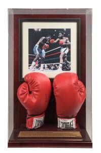 MUHAMMAD ALI, 'Everlast' boxing gloves (one signed - with 'Online Authentics' No. OA-7401320) mounted in display case with photograph & plaque, overall 43x69cm.