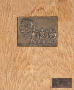 VICTORIAN OLYMPIC COUNCIL TROPHY: Plaque with bronze depicting Wilfred Kent Hughes 1895-1970, athletes with wreath and text "The Tribute of The Victorian Olympic Council", and smaller plaque lower right engraved "Melbourne 1956, Anthony Marchant & Ian Bro