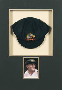 AUSTRALIAN "BAGGY GREEN" TEST CAP, c1980's, green wool with embroidered Australian Coat-of-Arms on front, signed on brim by Don Bradman. Window mounted with photo of Bradman, framed & glazed, overall 49x68cm.