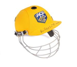 PAUL REIFFEL'S AUSTRALIAN XI HELMET, from the Australian XI v England XI match at Hobart during the 1998-99 Ashes Tour, yellow with embroidered ACB logo on front, and protective grill, fine condition with Reiffel's signature on brim. With Paul Reiffel col