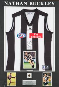 NATHAN BUCKLEY: Signed Collingwood jumper, window mounted with replica Brownlow Medal & three photographs; framed & glazed (glass cracked), overall 81x109cm. With CoA.