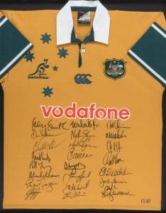 WALLABIES, jersey signed by 2002 Wallaby Squad, with 25 signatures including George Smith, Owen Finegan, Toutai Kefu, Stephen Larkham & Chris Latham. Window mounted, framed & glazed, overall 85x105cm. With CoA.