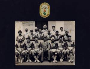 INDIA: Signed photograph of the gold medal winning India hockey team, with 18 signatures, in window mount decorated with Melbourne Olympics logo, overall 30x23cm.