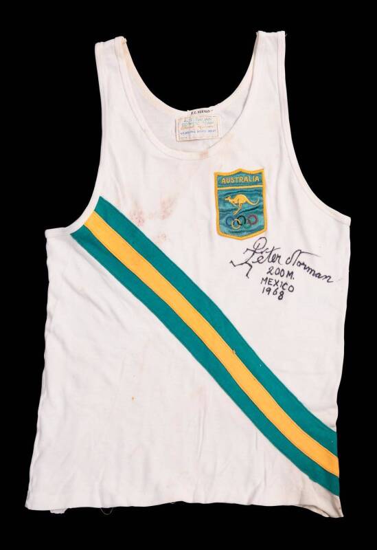 BLACK POWER SALUTE: Peter Norman's Australian running uniform from 1968 Mexico Olympics, white singlet with diagonal green/gold/green stripes, and cloth badge "Australia/ (kangaroo)/ (Olympic rings)". singlet endorsed "Peter Norman, 200M, Mexico 1968".