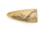 A scrimshaw whale's tooth. 9.5cm