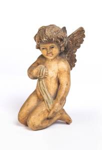 Carved polychrome figure of a cherub, 19th century. 16cm 