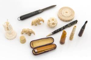 Group of four cigar and cigarette holders, pocket knife, pencil and group of ivory items including two elephants, carved ball on stand and a bakelite thimble. (10 items)