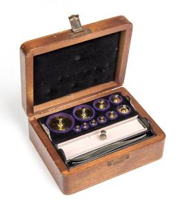 Set of gold weights in wooden box with silver name plaque "J.COLLINGWOOD". 5cm high, 12.5cm wide, 10cm deep