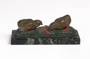 A French painted cast metal statue of chicks, on base, c1930s. 22cm long