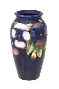 Moorcroft pottery "Pansy" patterned vase on blue ground. circa 1930s. 18cm