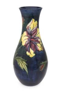 Moorcroft pottery "Hibiscus" patterned vase on blue/green ground, Royal warrant label on base, late 1930s. 26.5cm