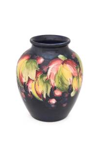 Moorcroft pottery "Leaves and Berries" patterned vase, late 1920s early 1930s. 15.5cm