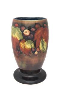 Moorcroft pottery flambe "Leaves and Berries" patterned vase, circa 1920s. 23cm