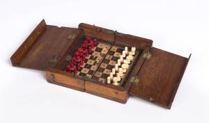 An antique traveling chess set with carved bone pieces in mahogany box. Closed 6cm high, 15cm wide, 7cm deep