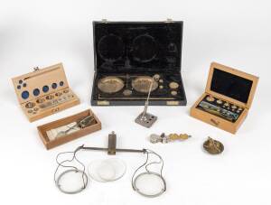 Scales and weights; group comprising boxed weights (2), Avery pocket sovereign scales, glass hanging scales, portable gold scales and boxed set of scales, 19th and 20th Century. 