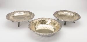 A French silver and silver gilt circular dish and a similar like-pair of dishes each raised on four scroll feet by Victor Boivin, 5 Rue de Montmorency, Paris, circa 1900